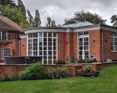 Refurbished traditional property with elegant brick exterior and landscaped garden.