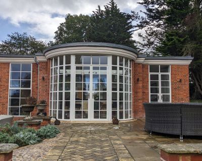 Front view showcasing the brick extension of a traditional property with garden pathways.