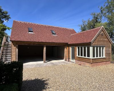 Front elevation of the new cartlodge and studio, showcasing the timber frame and modern design.