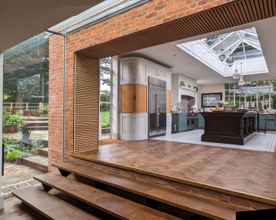 Spacious kitchen-diner area with glass lantern roof and modern furnishings.