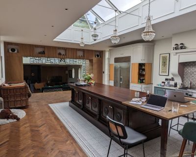 Interior kitchen-diner with skylight lantern, modern decor, and large dining area.