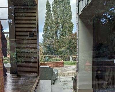 Side view of glazed link block in architecturally redesigned traditional property.