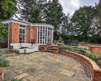 Back view of the refurbished traditional property with garden and outdoor seating area.