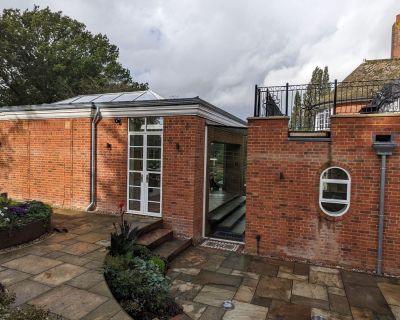 Detailed view of the brick extension with pathway and landscaped garden at traditional property