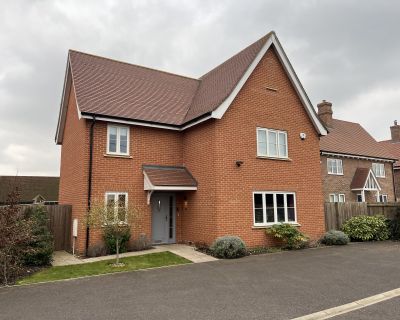 Detached house in Phase 1 of the residential development with a pitched roof and traditional facade.