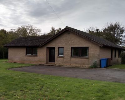 Front view of the 1980s bungalow in its original state, with dated brickwork and roof structure.