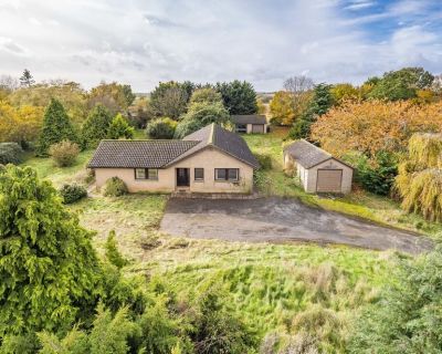 Aerial shot of the 1980s bungalow on a large plot, showing the condition before refurbishment.