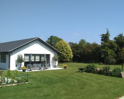 Side view of the refurbished 1980s bungalow, highlighting clean lines and updated exterior.